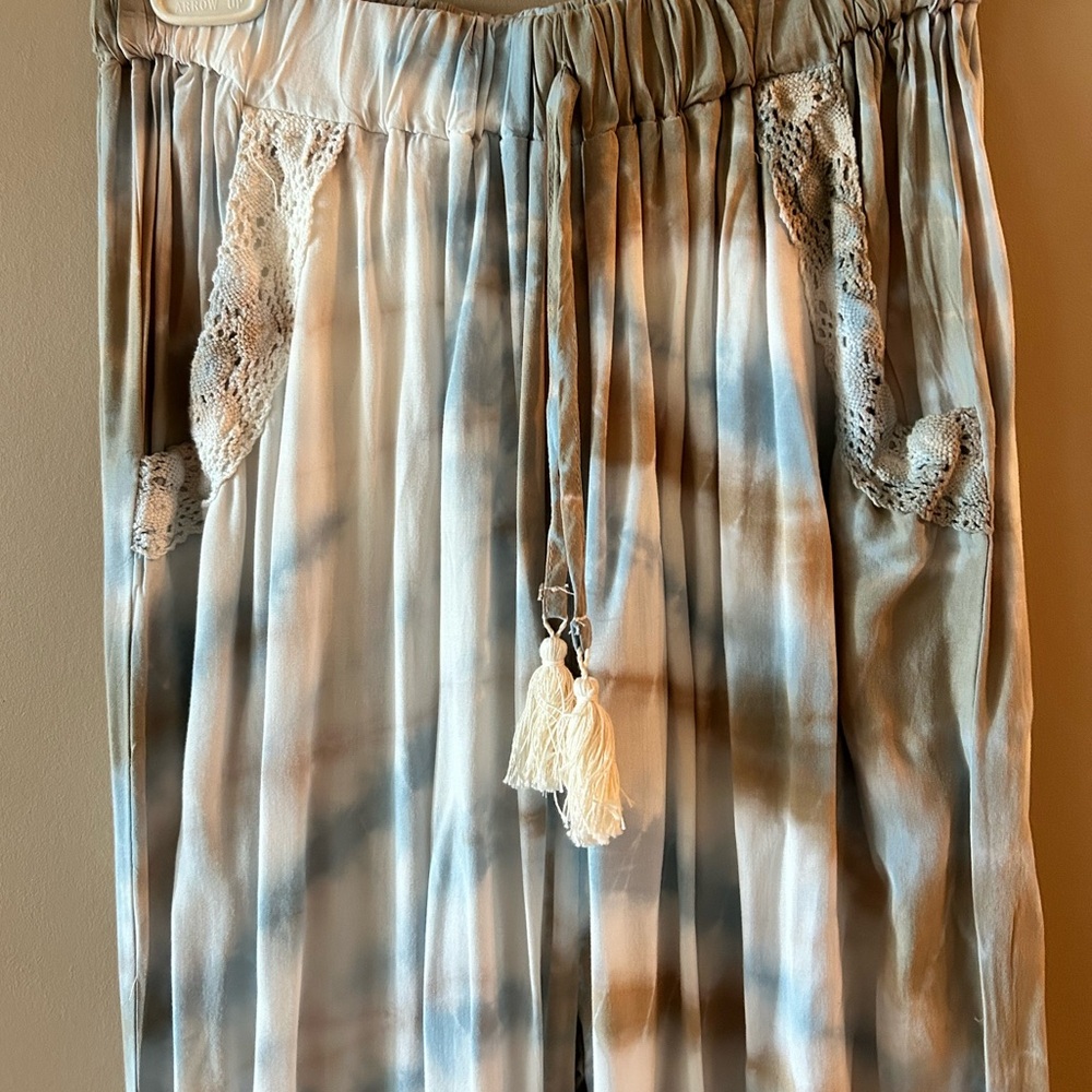 Gypsy style float pant. Side Pockets. Fringe opening on each side.